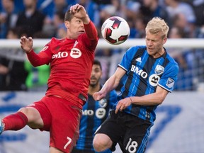 TFC forward Will Johnson (left) battles with Impact midfielder Kyle Bekker in Montreal last night. (The Canadian Press)