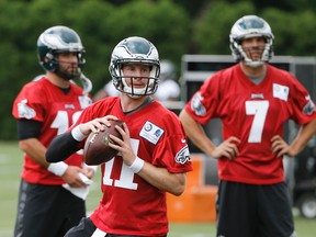 Eagles quarterback Carson Wentz (11) throws a pass as Sam Bradford (7) and Chase Daniel (10) look on during practice at the team's training facility in Philadelphia on Tuesday, June 7, 2016. (Matt Rourke/AP Photo)