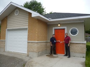 Myles Vanni, executive director of the Inn of the Good Shepherd, and John Gott, manager of Sarnia's Home Depot, are pictured here outside a new storage building located at the Good Shepherd's Lodge on Confederation Street. Community partners came together to build the 1,200-square-foot space in order for clients of the homeless shelter to have a safe place to store their belongings. (Handout)