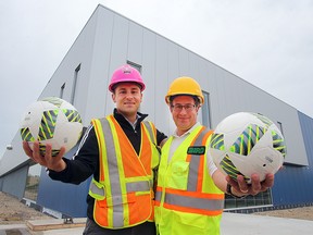 Carlo Bruneau (left) and Devon Ashton stand outside the Winnipeg Soccer Federation North. The new facility is expected to open next month. (Brian Donogh/Winnipeg Sun)