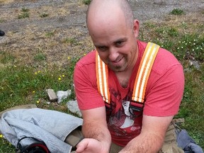 Fort Erie Fire Station 4 Captain Dean Smalldon holds a puggle moments after he helped rescue the one-week-old puppy from a pipe in a drainage ditch in front of a Gorham Road home on Wednesday, June 8, 2016 in Fort Erie, Ont. (Fort Erie SPCA/Special to the Fort Erie Times/Postmedia Network)