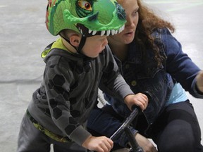 Parent Link's Abby Zur helps young Daxon Mackenzie figure out the bike safety course.