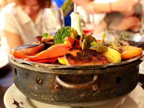 This picture taken March 13, 2016, shows grilled vegetables as served at El Palenque, one of the parillas, or grill restaurants, in Montevideo's Mercardo del Puerto, a popular place for lunch. (Michelle Locke via AP)