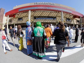 People arrive at Freedom Hall for an Islamic funeral prayer service for Muhammad Ali Thursday, June 9, 2016, in Louisville, Ky. (AP Photo/Mark Humphrey)