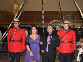 Trey Shining Double with his escort at Friday night's graduation ceremony.