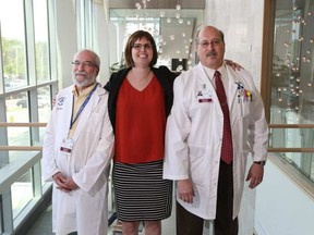 Dr. Harry Atkins, Jennifer Molson and Dr. Mark Freedman pose for a photo at the General Hospital in Ottawa.(Tony Caldwell, Postmedia)