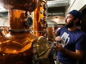 Head brewer Spike Baker checks his still as a cleanup crew works inside Wood Buffalo Brewing Company in Fort McMurray, Alta., on Thursday June 9, 2016. The company is hoping to re-open after the Fort McMurray wildfires next week. Photo by Ian Kucerak