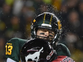 Mike Reilly is hit during a rainy game against the Calgary Stampeders last season. (File)