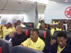 South African firefighters are seen on a an Air Canada plane in Johannesburg, South Africa destined for Edmonton on Sunday, May 29, 2016 in this handout photo. A group that employs 300 South African firefighters on loan to Alberta to battle the Fort McMurray blaze says it is bringing its workers home after they complained about what they are being paid.THE CANADIAN PRESS/HO-CNW Group/Air Canada