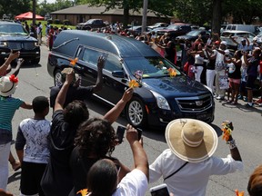 The funeral procession for Muhammad Ali makes its way down Muhammad Ali Boulevard in Louisville, Ky. Friday, June 10, 2016. (AP Photo/Michael Conroy)