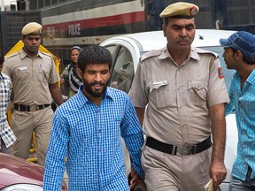 In this Thursday, June 9, 2016, photo, three of the five convicts in the gang rape of a 51-year-old Danish tourist in 2014, are escorted by the police for a hearing at a city court, in New Delhi, India. (AP Photo/Manish Swarup)