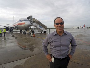 In this Thursday, June 9, 2016, photo, Galo Beltran, Cuba country manager for American Airlines, poses for a picture near a charter flight operated by American at Havana’s Jose Marti International Airport. Beltran is based in Dallas. The Department of Transportation said Friday that six airlines: American, Frontier, JetBlue, Silver Airways, Southwest and Sun Country, have been selected for routes to nine Cuban cities other than Havana. (AP Photo/Scott Mayerowitz)