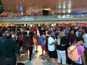 People are gathered inside Dallas Love Field airport after an officer-involved shooting prompted a lockdown Friday, June 10, 2016, in Dallas.  (Brian Elledge/The Dallas Morning News via AP)