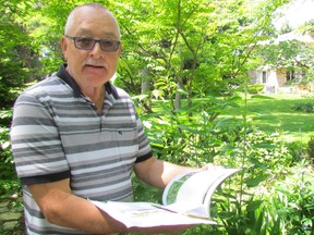 David Nichols checks a reference book on native plants while standing in the garden of his Sarnia home on Thursday June 9, 2016. Nichols is one of the growing number of homeowners turning to indigenous plants.
Paul Morden/Sarnia Observer/Postmedia Network