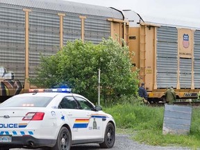 Police attend the scene of a fatal train accident in Lantz, Nova Scotia on Friday, June 10, 2016. Two young women, one an exchange student from Germany, were pronounced dead in the early morning accident. THE CANADIAN PRESS/Andrew Vaughan