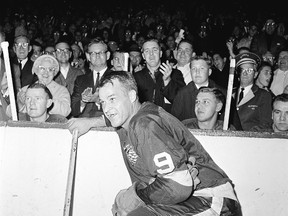 In this Nov. 10, 1963 file photo, Detroit Red Wings forward Gordie Howe (9) acknowledges applause from the fans during a 20-minute standing ovation after he scored the 545th goal of his National Hockey League career at Detroit’s Olympia Stadium. (AP Photo/File)
