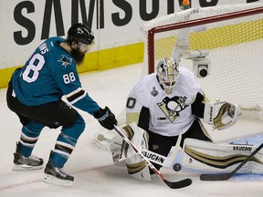 Penguins goalie Matt Murray (right) defends a shot by Sharks defenceman Brent Burns (left) during Game 3 of the Stanley Cup final in San Jose, Calif., on Saturday, June 4, 2016. (Eric Risberg/AP Photo)