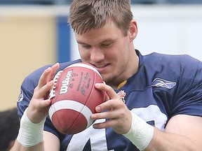 Winnipeg Blue Bombers defensive lineman Trent Corney catches a ball during CFL football practice. (Brian Donogh/Winnipeg Sun file photo)