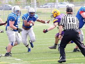Bankamina N'Galamulume, middle, of the Sudbury senior Gladiators, looks for an opening during football action against the Huronia Stallions at James Jerome Sports Complex in Sudbury, Ont. on Saturday June 4, 2016. John Lappa/Sudbury Star/Postmedia Network
