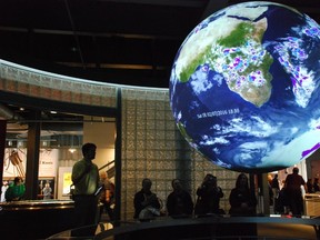 Ocean Planet at GulfQuest in Mobile, Ala., is a two-metre-diameter Earth, rotating on its axis. Visitors engage with real-time satellite data and images to view the planet. (WAYNE NEWTON/Special to Postmedia News)
