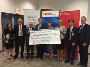 Celebrating 3M Canada?s $600,000 donation Friday toward personalized medicine research at London hospitals are Michelle Campbell, left, of St. Joseph?s Health Care Foundation; Dr. David Hill and Dr. Frank Prato of Lawson Health Research Institute; 3M Canada president Paul Madden; Dr. Gillian Kernaghan, president, St. Joseph?s Health Care London; Laurie Gould and Dr. Richard Kim of London Health Sciences Centre; and Chris Boucher of London Health Sciences Foundation. (Hala Ghonaim, The London Free Press)