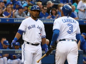 Blue Jays' Ezequiel Carrera (right) scored the first run of the game in the first inning and is congratulated by Edwin Encarnacion (left) against the Orioles during MLB action in Toronto on Friday, June 10, 2016. (Dave Abel/Toronto Sun)