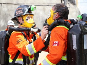 John Lappa/Sudbury Star
Vale West Mines team members check their breathing apparatus while taking part in a mine rescue scenario at the annual Provincial Mine Rescue Competition at NORCAT's underground training centre in Onaping on Friday.