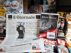 Il Giornale newspaper is seen on sale in a newsstand with Hitler's "Mein Kampf", in Rome Saturday, June 11, 2016. The conservative Milan daily Il Giornale  has published Hitler’s political manifesto ‘’Mein Kampf,’’ angering Italy’s premier and the tiny Jewish community. (AP Photo/Fabio Frustaci)