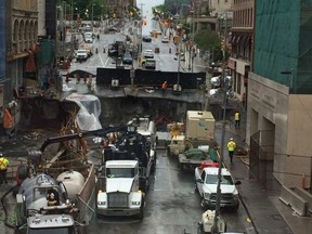 Work continued Saturday on the Rideau Street sinkhole, seen here from the Rideau Centre pedestrian bridge. Blair Crawford/Postmedia