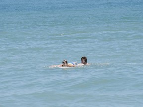 Third Eye Blind frontman Stephan Jenkins is pictured rescuing one kid who was swept out at sea. (Twitter.com/ThirdEyeBlind