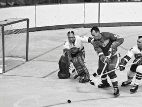 In this Oct. 26, 1967, file photo, California Seals goalie Charlie Hodge knocks the puck away as Detroit Red Wings’ star Gordie Howe closes in. Legendary jockey Sandy Hawley serves as a penalty box attendant at the old Forum in Los Angeles and was a huge fan of Howe. (AP/PHOTO)