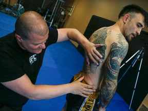 Alin Halmagean checks out a cut on fighter Denis Puric at his gym, House of Champions in Stoney Creek, Ont. on Tuesday May 31, 2016. Dave Thomas/Toronto Sun/Postmedia Network