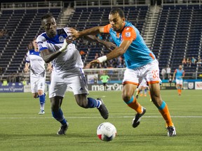 FC Edmonton defender Papé Diakité battles for the ball with Miami FC striker Pablo Campos. Miami won 1-0.