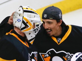 Pittsburgh Penguins' Matt Murray, left, is greeted by fellow goalie Marc-Andre Fleury after the Penguins defeated the Tampa Bay Lightning in Game 7 of the NHL hockey Stanley Cup Eastern Conference finals, Thursday, May 26, 2016, in Pittsburgh. The Penguins won 2-1 and advanced to the Stanley Cup finals. (AP Photo/Gene J. Puskar)