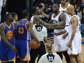 Cleveland Cavaliers forward LeBron James is held back as he argues with Golden State Warriors forward Draymond Green during the second half of Game 4 of basketball's NBA Finals in Cleveland, Friday, June 10, 2016. (AP Photo/Tony Dejak)