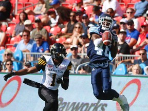 Argos defensive back TJ Heath picks off a Jeff Mathews pass intended for Hamilton Tiger-Cats’ Tiquan Underwood during the second quarter on Saturday at BMO Field. The Argos beat the Ticats 25-16 in the pre-season opener for both teams. (JACK BOLAND/TORONTO SUN)