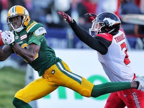 Edmonton Eskimos' Bryant Mitchell with a touchdown catch in front of Adam Thibault of the Calgary Stampeders in CFL football in Calgary, Alta. on  June 11, 2016.