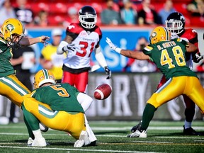 Edmonton Eskimos kicker Sean Whyte  kicks a field goal against Calgary Stampeders, as quarterback Jordan Lynch holds during CFL football in Calgary, Alta. on  June 11, 2016.