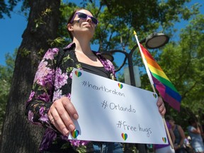 A woman offers free hugs in Washington, DC on June 12, 2016, in reaction to the mass shootings at a gay club in Orlando, Florida.
A somber President Barack Obama expressed grief and outrage at the "horrific massacre" of 50 late-night revelers at an Orlando gay club, branding it an act of terror and hate. / AFP PHOTO / ANDREW CABALLERO-REYNOLDS