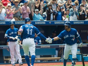 Toronto Blue Jays Kevin Pillar is greeted by teammate Russell Martin after hitting a solo home run during third inning American League baseball action against the Baltimore Orioles in Toronto on Sunday June 12 , 2016. THE CANADIAN PRESS/Eduardo Lima