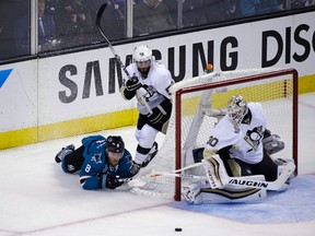 San Jose Sharks center Joe Pavelski and Pittsburgh Penguins defenseman Kris Letang battle for the puck as Penguins goalie Matt Murray looks on during the third period of Game 4 of the NHL hockey Stanley Cup Finals. (AP Photo/Eric Risberg)