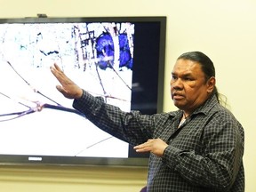 George Stephen, an indigenous man who lived homeless for 20 years, explains his interpretation of a photograph at the launch of Living on the Outside, a multimedia exhibit exploring the realities of home at the Gallery 6500 at the United Steelworkers Hall on Sunday. (Gino Donato/Sudbury Star)