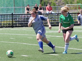 Danielle Pominville, left, of Sacre-Coeur, and Sarah Belanger, of Espanola High School, chase after the ball during girls division II semifinal action at James Jerome Sports Complex in Sudbury, Ont. on Thursday June 9, 2016. Sacre-Coeur faces Bishop Carter in the Division II final Monday at 4 p.m. at James Jerome. John Lappa/Sudbury Star/Postmedia Network