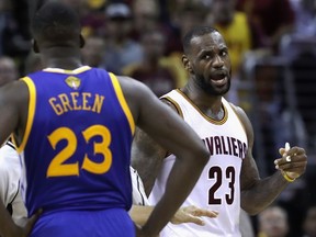 LeBron James of the Cleveland Cavaliers and Draymond Green of the Golden State Warriors exchange words during a time out during the fourth quarter in Game 4 of the 2016 NBA Finals at Quicken Loans Arena on June 10, 2016 in Cleveland, Ohio.  (Ronald Martinez/Getty Images/AFP)