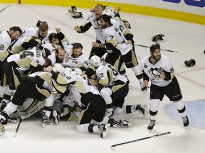 Pittsburgh Penguins players celebrate after beating the San Jose Sharks in Game 6 of the NHL hockey Stanley Cup Finals in San Jose, Calif., Sunday, June 12, 2016. The Penguins won 3-1 to win the series 4-2. (AP Photo/Eric Risberg)