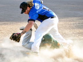 Bret Kraemer, third baseman of the Mitchell Mets, looks for a throw to the bag while this Puslinch runner dives into the base in a cloud of dust during action last Saturday, June 11 at Keterson Park, part of the annual men’s fastball tournament. ANDY BADER MITCHELL ADVOCATE