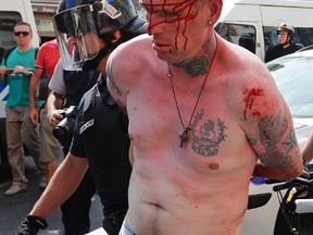 A man is arrested by police officers in downtown Marseille, France, on Saturday, June 11, 2016. Riot police have thrown tear gas canisters at soccer fans Saturday in Marseille's Old Port in a third straight day of violence in the city.  (Darko Bandic/AP Photo)