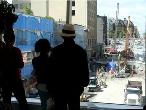 The Rideau Street sinkhole is proving a popular attraction at the Rideau Centre. The Rideau Street walkway provides a bird's eye view of the work. JULIE OLIVER / OTTAWA CITIZEN