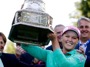 Brooke Henderson lifts the championship trophy after winning the Women's PGA Championship at Sahalee Country Club in Sammamish, Wash., on Sunday, June 12, 2016. (Elaine Thompson/AP Photo)