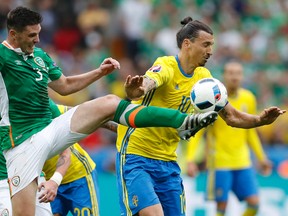 Sweden's Zlatan Ibrahimovic, right, is challenged by Ireland's Ciaran Clark during the Euro 2016 Group E soccer match between Ireland and Sweden at the Stade de France in Saint-Denis, north of Paris, France, Monday, June 13, 2016. (AP Photo/Christophe Ena)